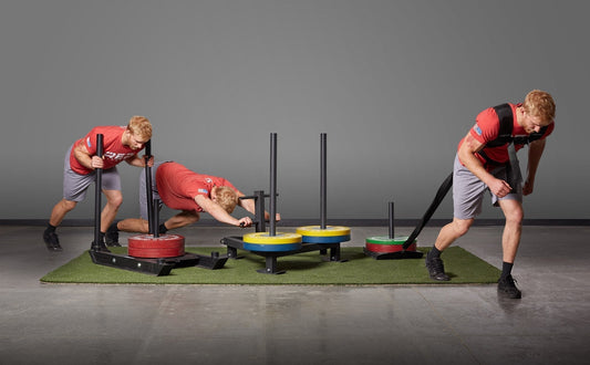 Athlete pushes and pull a sled.