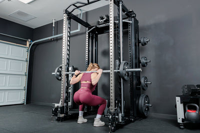Athlete squatting using the REP Fitness Altitude™ Power Rack Smith Machine Attachment